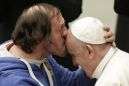 Pope tenderly kissed on forehead by man in front-row seat