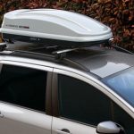 Car roof boxes are attached to the top of a vehicle