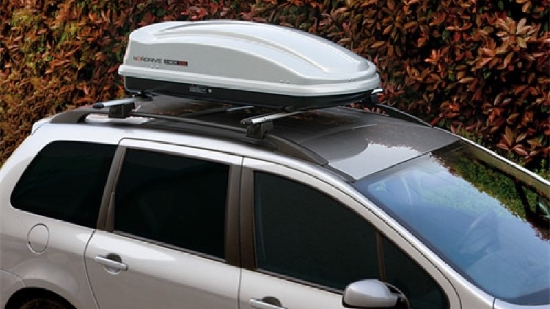 Car roof boxes are attached to the top of a vehicle